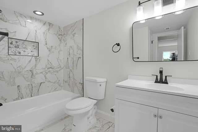 a bathroom with a sink a toilet and a bathtub