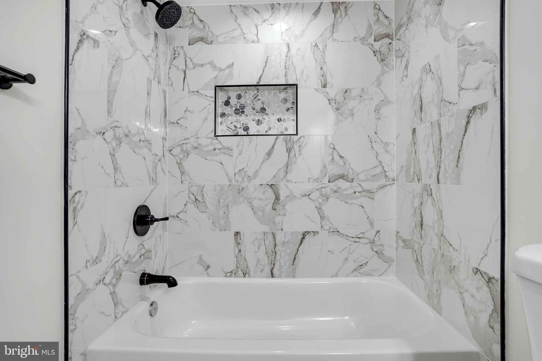 10239 Prince Place, Unit 26103 Upper Marlboro, MD 20774 - Photo 21 of 25 a bathroom with a bathtub