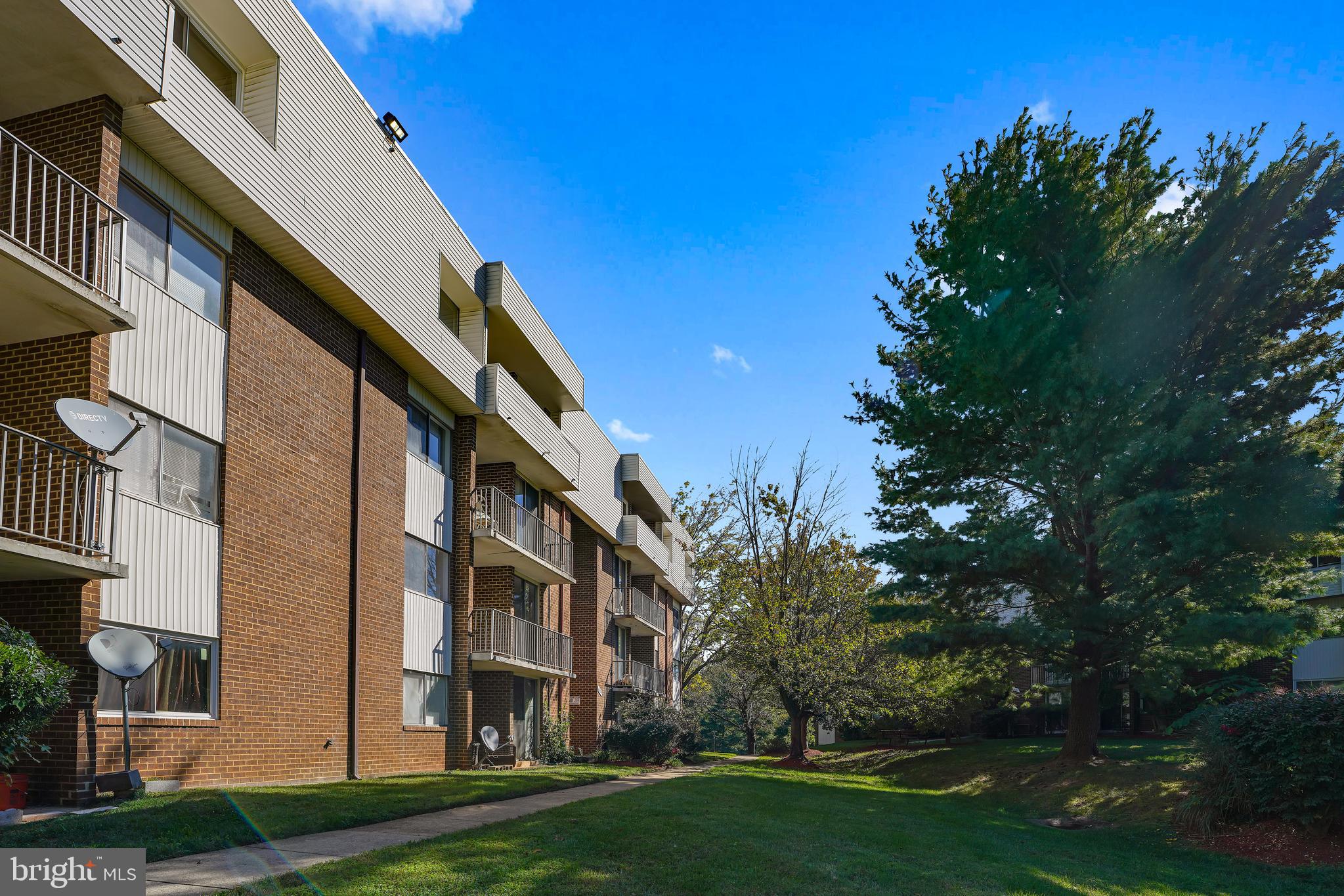 10239 Prince Place, Unit 26103 Upper Marlboro, MD 20774 - Photo 23 of 25 a view of a building with a yard