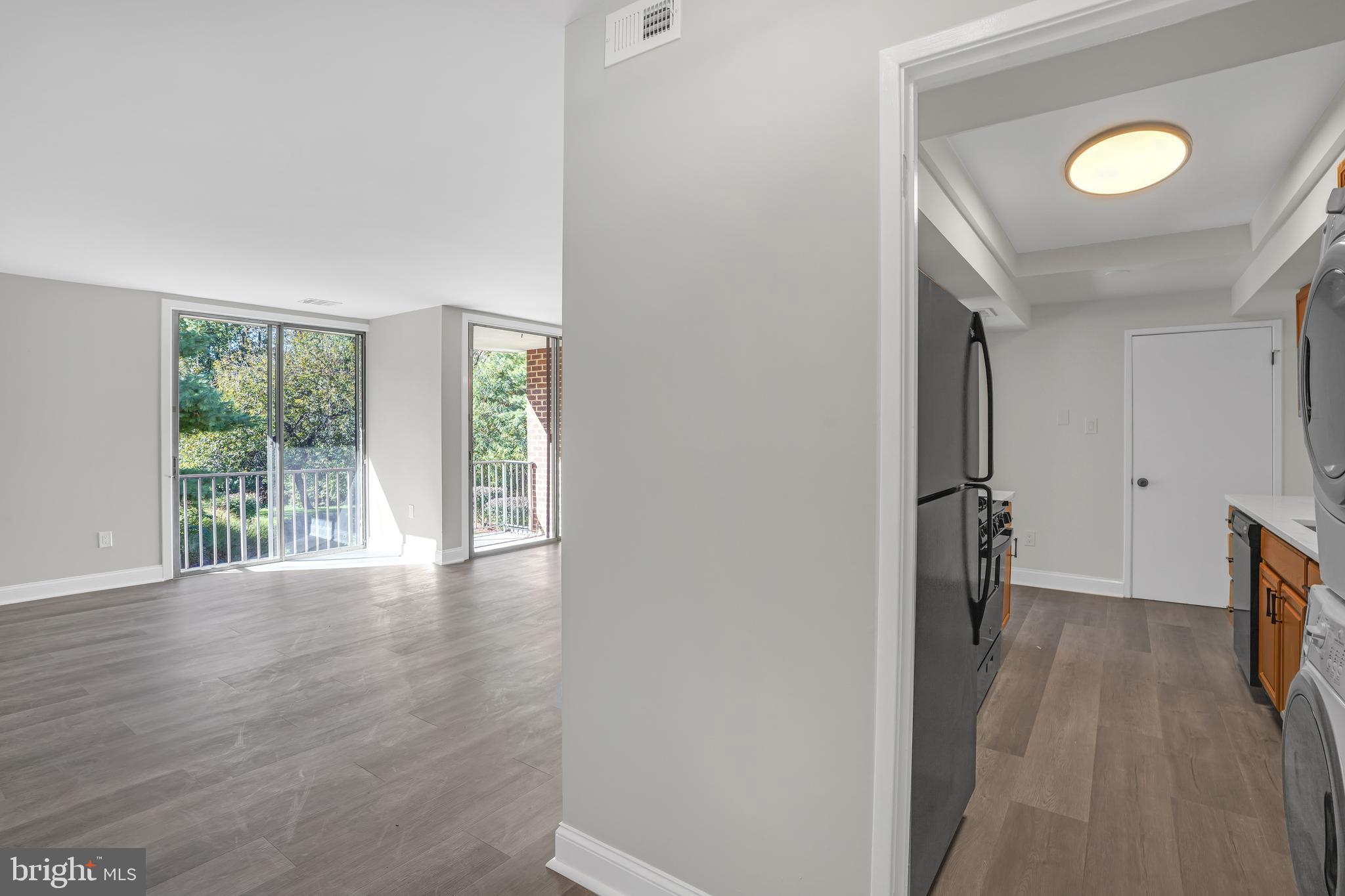 10239 Prince Place, Unit 26103 Upper Marlboro, MD 20774 - Photo 3 of 25 a view of hallway with wooden floor