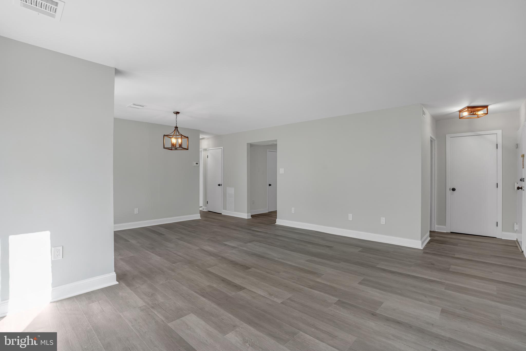 10239 Prince Place, Unit 26103 Upper Marlboro, MD 20774 - Photo 6 of 25 wooden floor in an empty room