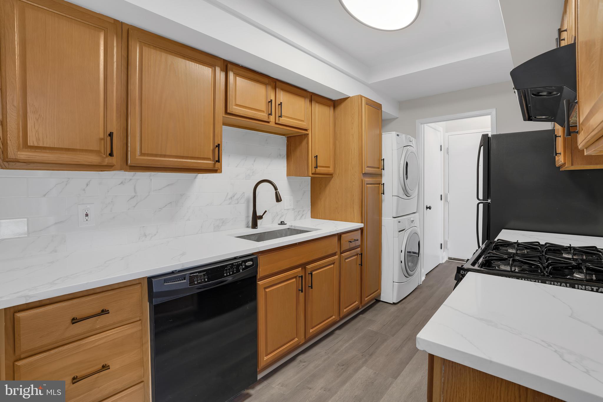 10239 Prince Place, Unit 26103 Upper Marlboro, MD 20774 - Photo 9 of 25 a kitchen with a sink and cabinets