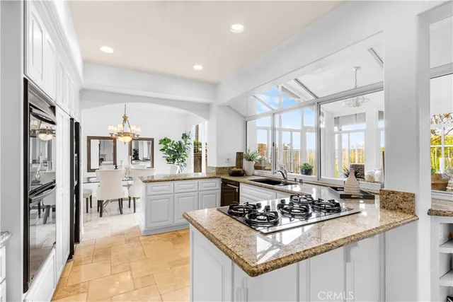 a kitchen with a stove a sink a refrigerator and cabinets