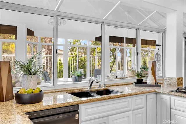 a kitchen with a large window and cabinets