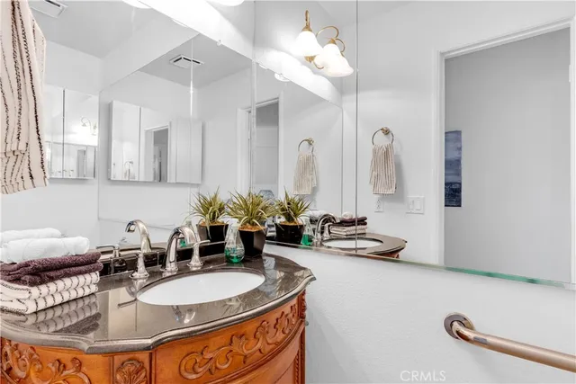 a bathroom with a double vanity sink and a mirror