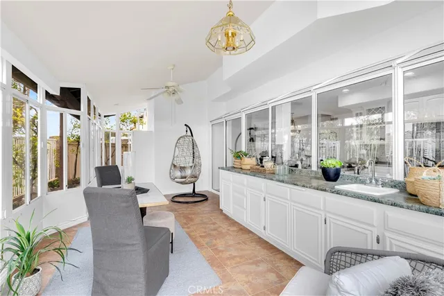 a living room with furniture a chandelier and a large window