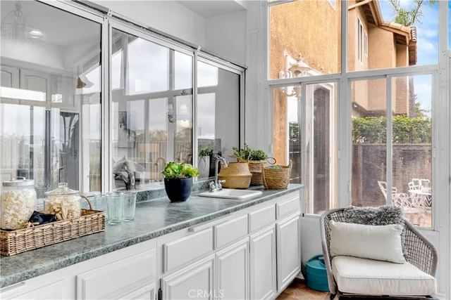 a kitchen with sink and large window