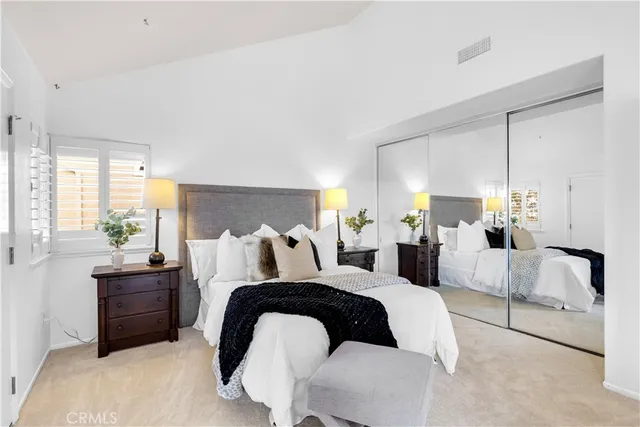 a bedroom with bed and a large window