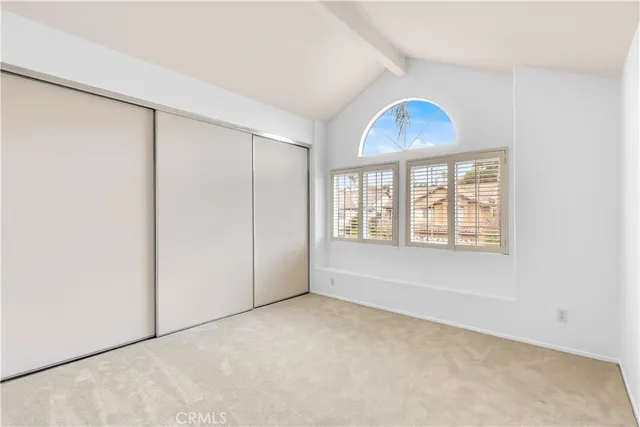 an empty room with windows and closet