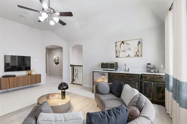 a living room with furniture and a potted plant