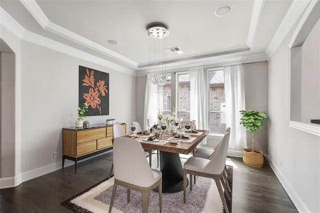 a kitchen that has a sink a table and chairs in it