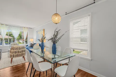 a dining room with furniture and wooden floor