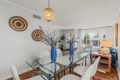 a view of a dining room with furniture and chandelier