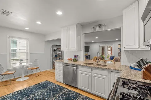 a kitchen with a sink stove and cabinets