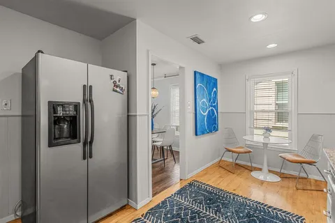 a kitchen with stainless steel appliances granite countertop a refrigerator and a sink