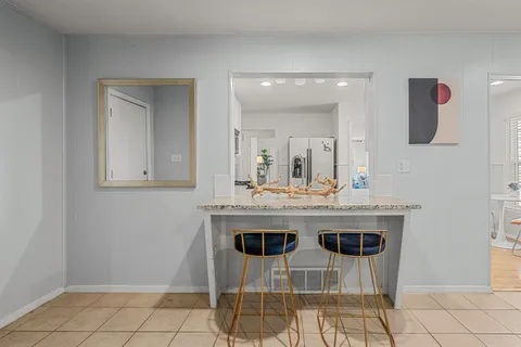 a kitchen with a sink cabinets and dining table