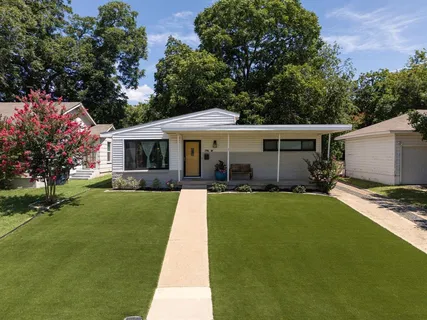 a front view of house with yard and green space