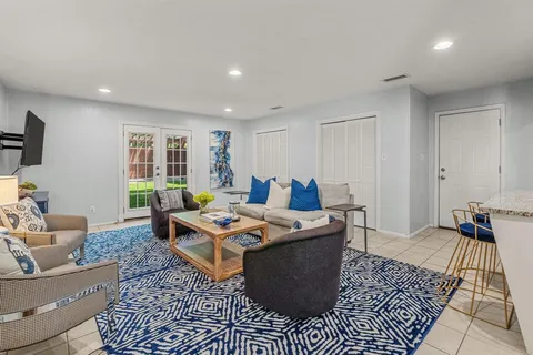 a living room with furniture a rug and a window