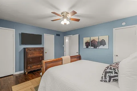 a bedroom with a bed and a chandelier