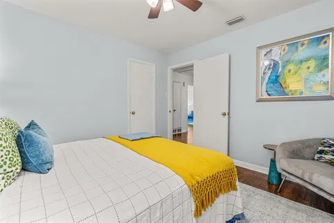 a bedroom with a bed and a painting on the wall