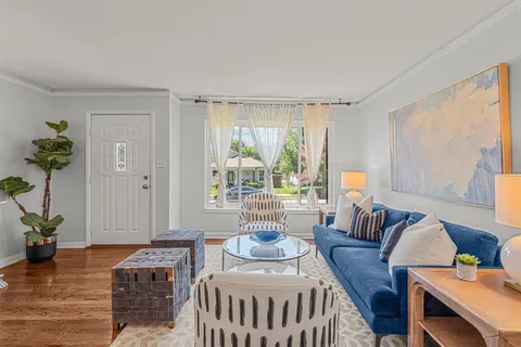 a bedroom with furniture and a wooden floor