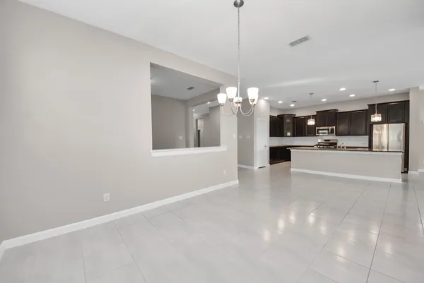 a view of kitchen with stainless steel appliances kitchen island a sink dishwasher a stove and a refrigerator with wooden floor