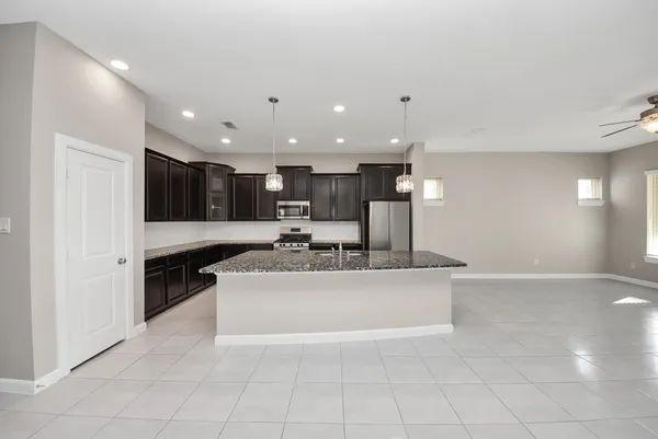 a large kitchen with stainless steel appliances kitchen island granite countertop a large counter top stainless steel appliances and cabinets