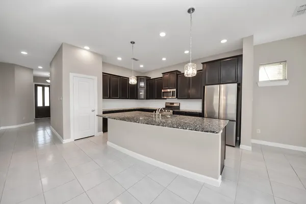 a kitchen with stainless steel appliances granite countertop a stove and a sink