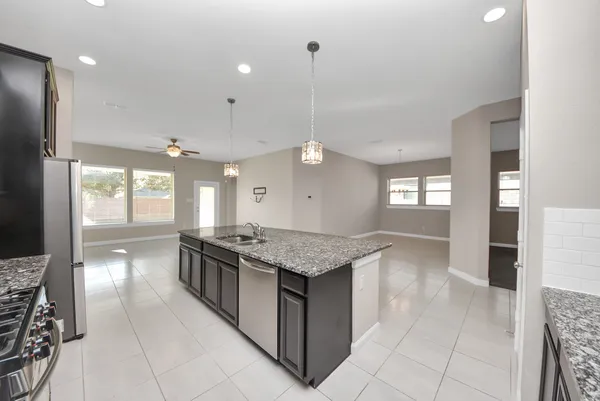 a kitchen with stainless steel appliances granite countertop a stove and a sink