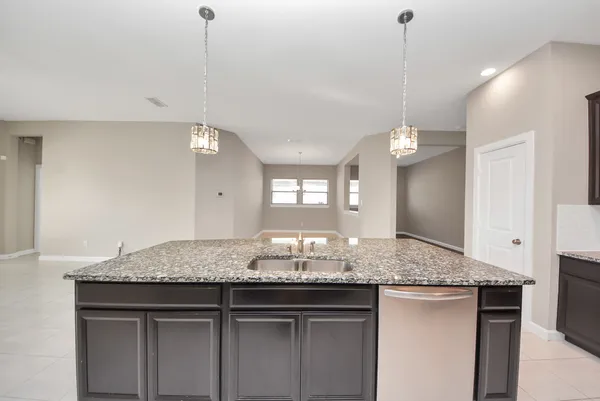 a large kitchen with stainless steel appliances granite countertop a large counter top and a stove top oven