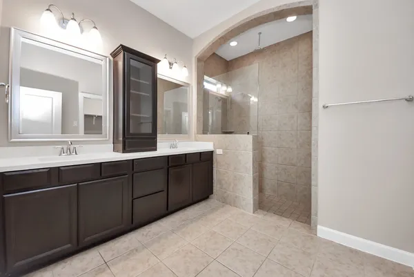 a bathroom with a double vanity sink and a mirror