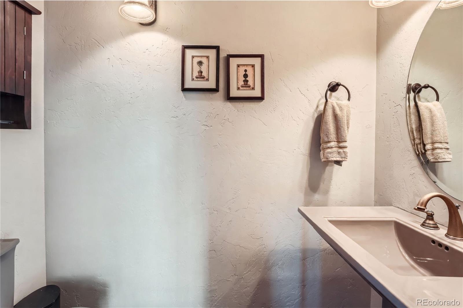 401 Raptor Point Golden, CO 80403 - Photo 31 of 44 a bathroom with a sink and mirror