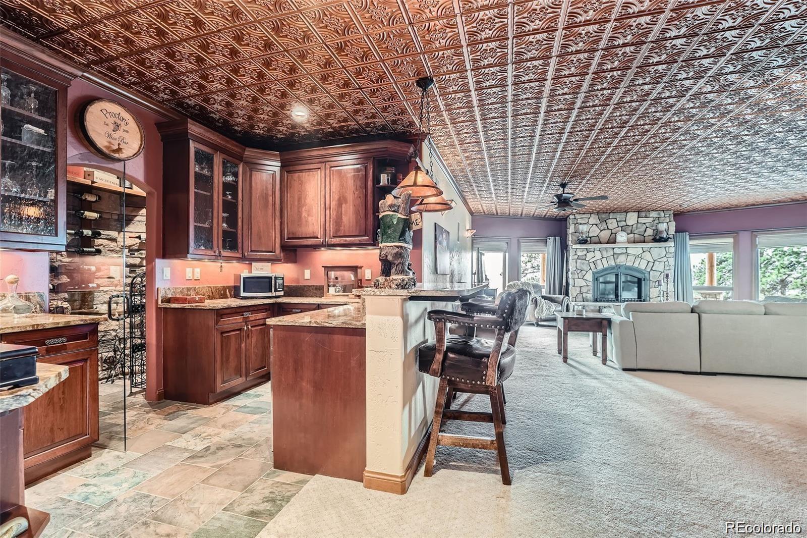 401 Raptor Point Golden, CO 80403 - Photo 32 of 44 a kitchen with lots of wooden cabinets appliances and furniture