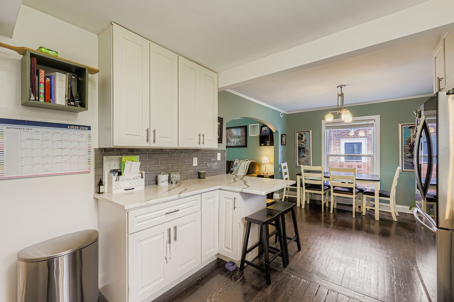 5346 Suffield Terrace Skokie, IL 60077 - Photo 11 of 27 a kitchen with a sink white cabinets and dining table chair
