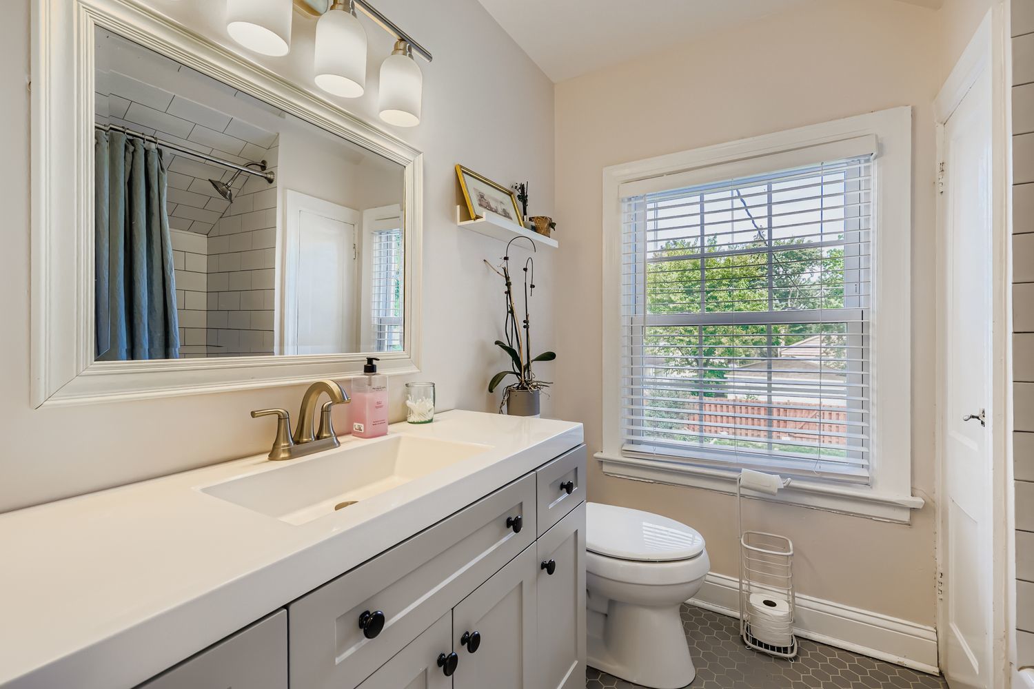 5346 Suffield Terrace Skokie, IL 60077 - Photo 17 of 27 a bathroom with a sink a toilet and a mirror
