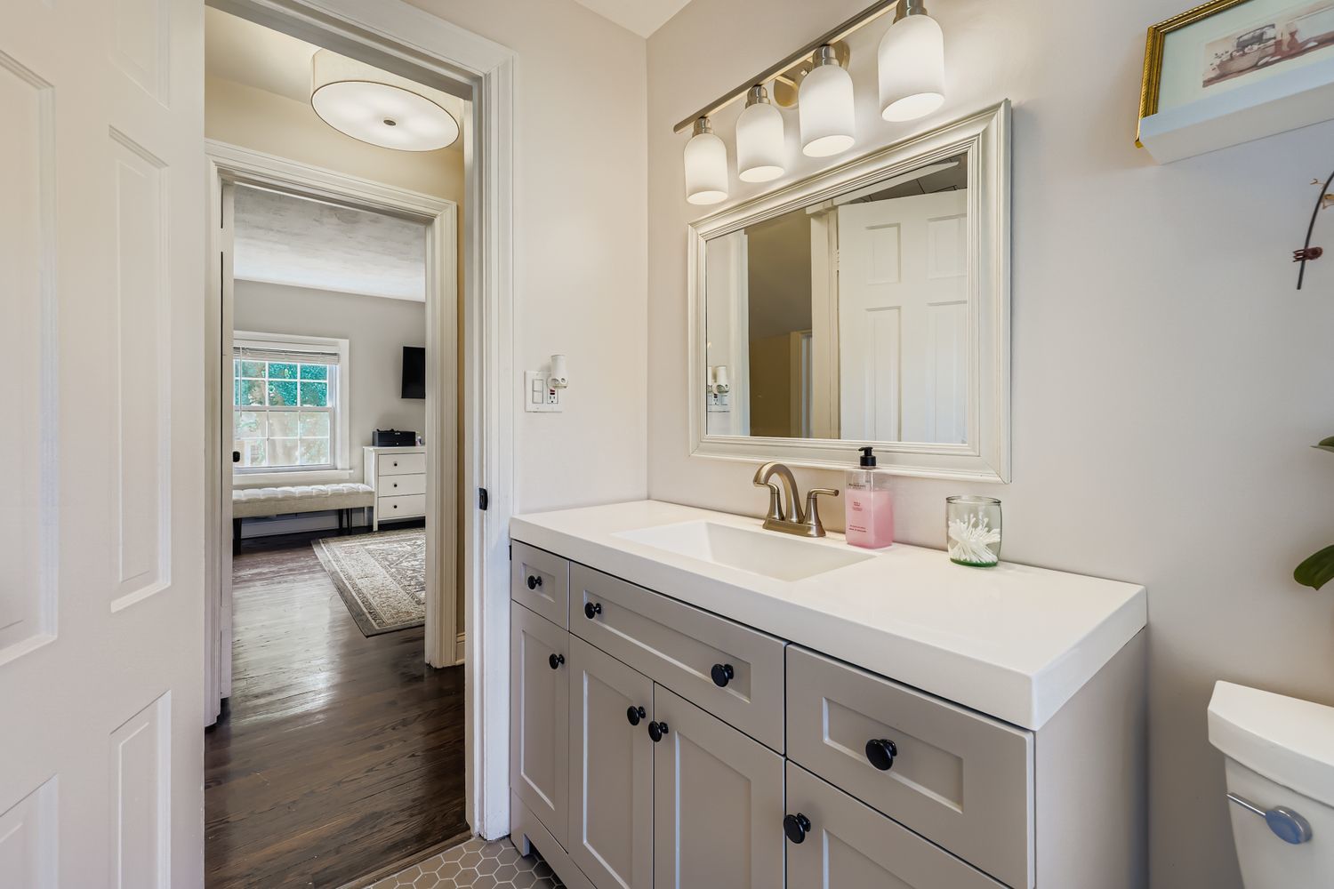 5346 Suffield Terrace Skokie, IL 60077 - Photo 18 of 27 a en suite bathroom with a sink a toilet and a mirror