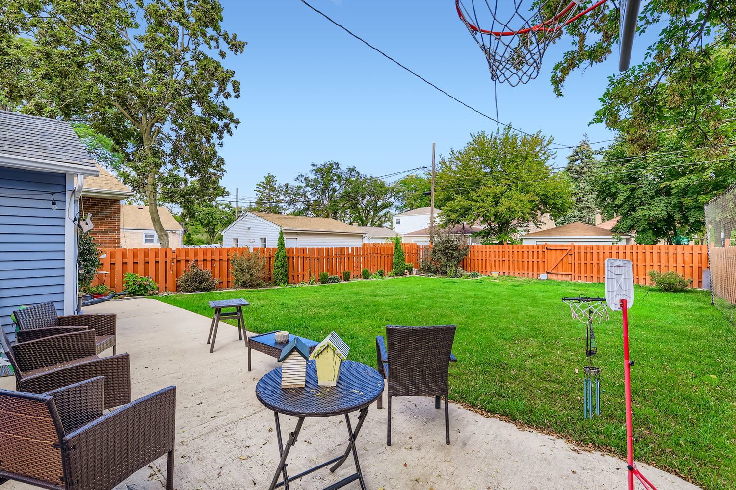 5346 Suffield Terrace Skokie, IL 60077 - Photo 25 of 27 a view of a backyard with table and chairs potted plants and a fire pit