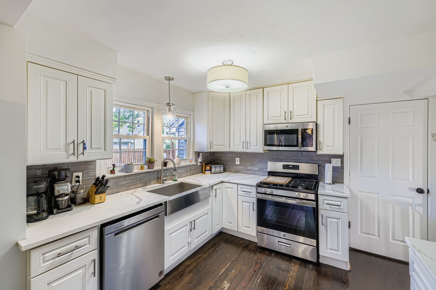 5346 Suffield Terrace Skokie, IL 60077 - Photo 9 of 27 a kitchen with stainless steel appliances granite countertop a stove a sink and white cabinets