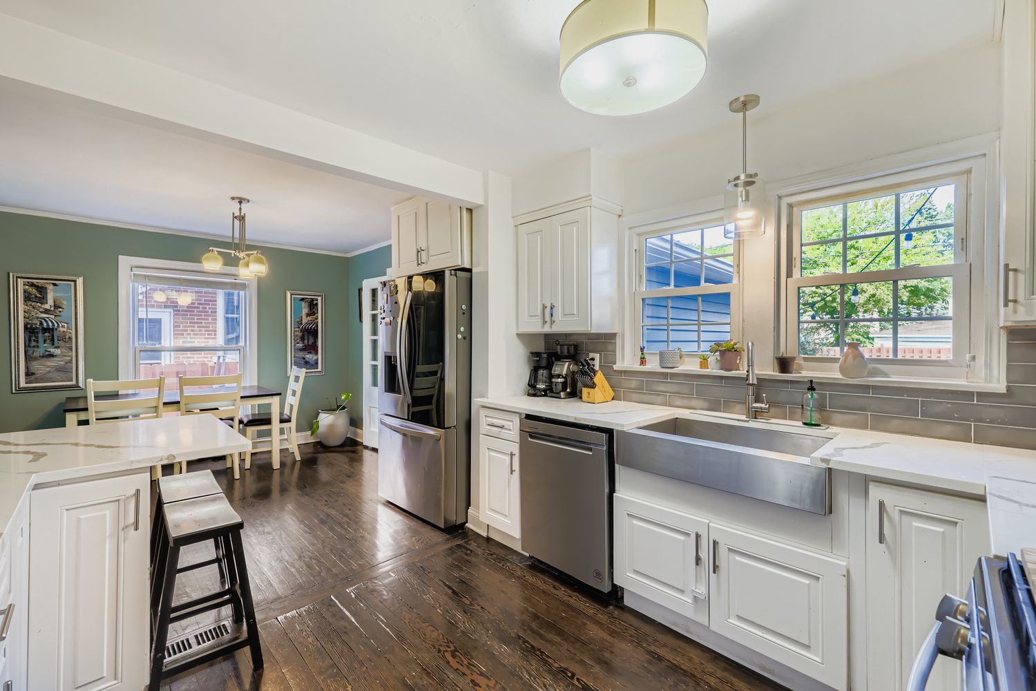 5346 Suffield Terrace Skokie, IL 60077 - Photo 10 of 27 a kitchen with stainless steel appliances a stove a sink a refrigerator dining table and chairs