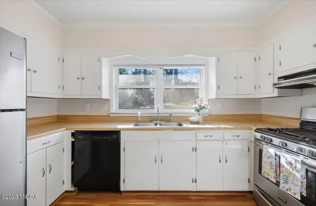 a kitchen with granite countertop a sink and a stove