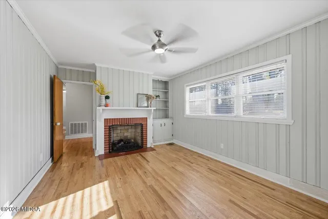 a view of an empty room with a fireplace and a window