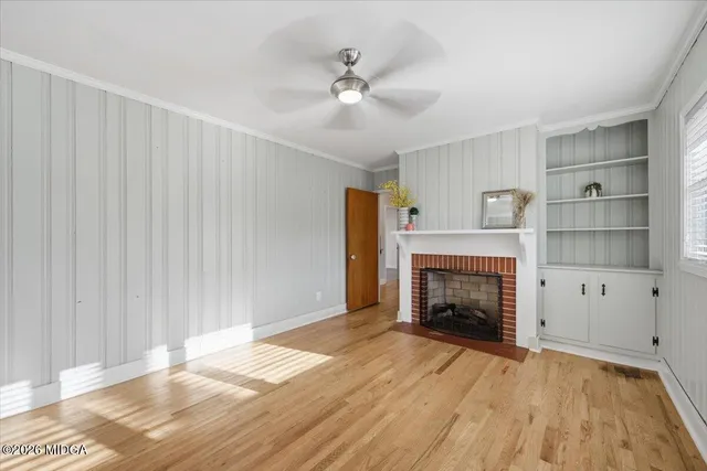 a view of an empty room with a fireplace and a window