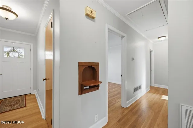 a view of hallway with wooden floor
