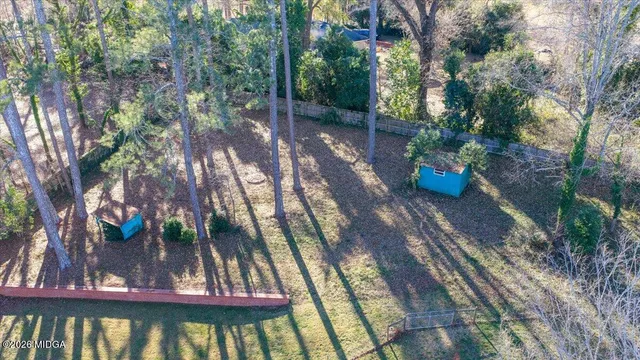 a view of a backyard with plants and a patio