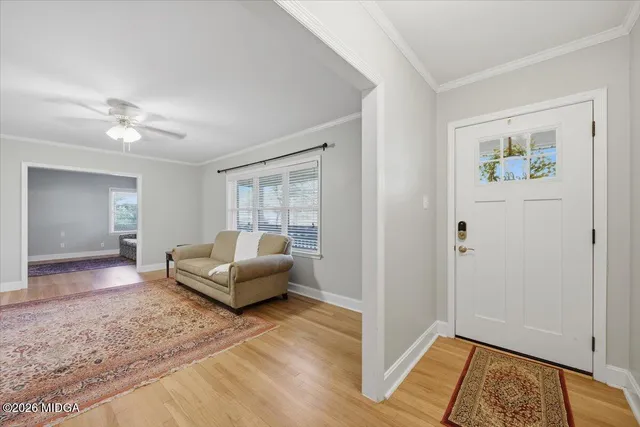 a living room with furniture and wooden floor