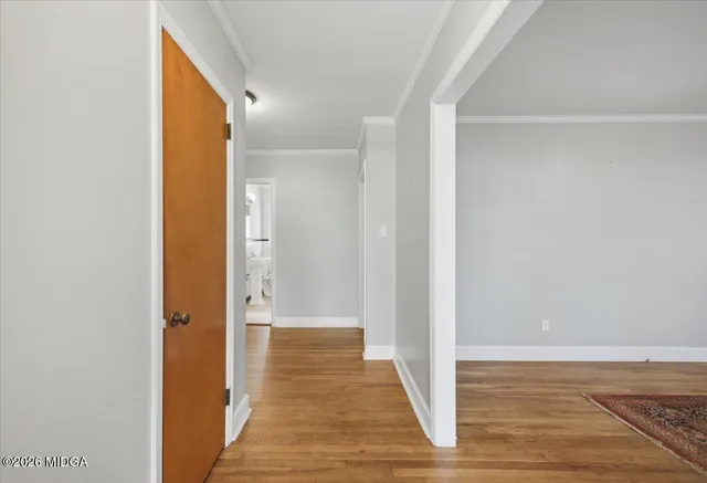 a view of a hallway with wooden floor