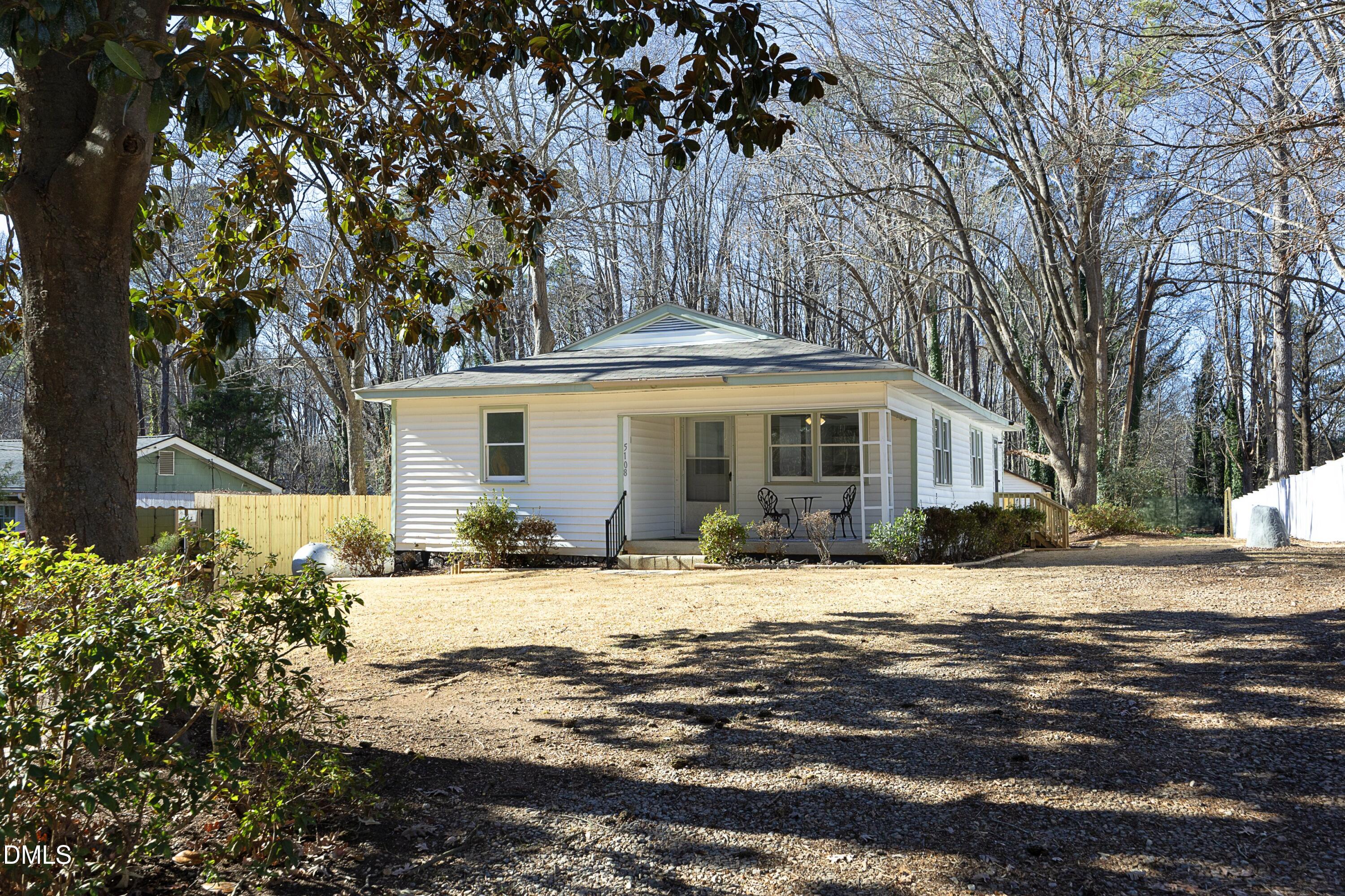 5108 Old Valley Street Raleigh, NC 27603 - Photo 1 of 37 a front view of a house with a yard and trees