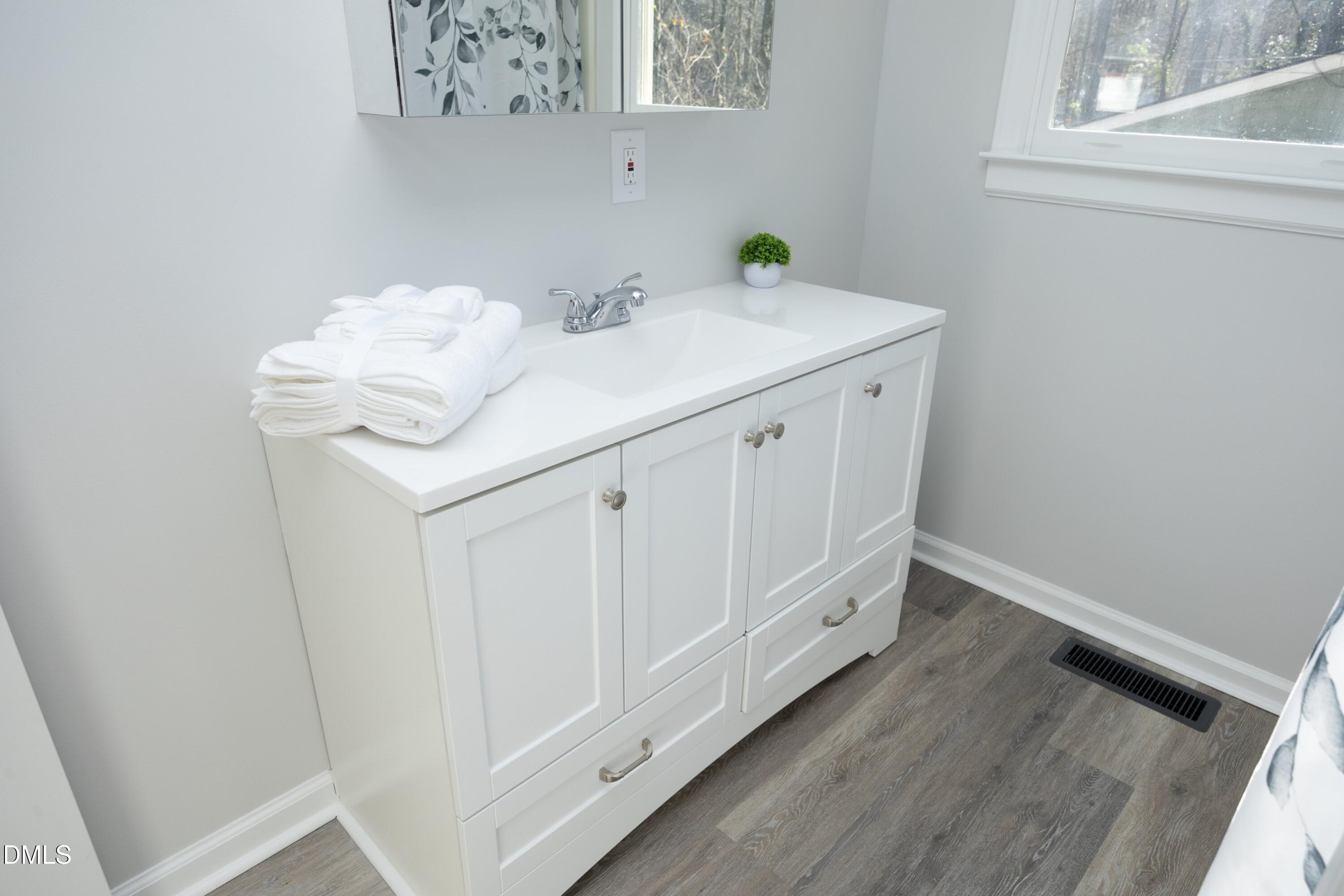 5108 Old Valley Street Raleigh, NC 27603 - Photo 19 of 37 a bathroom with a sink and a window