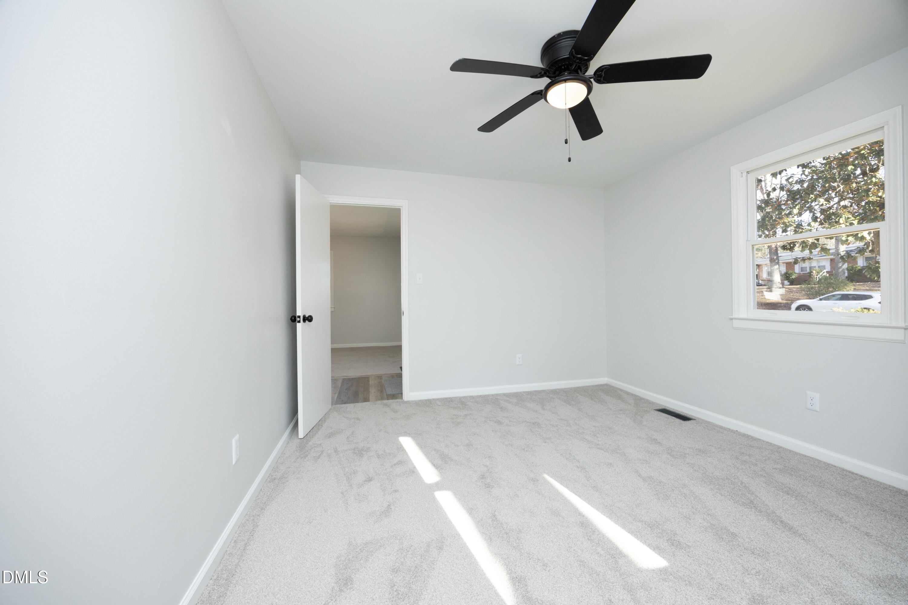 5108 Old Valley Street Raleigh, NC 27603 - Photo 22 of 37 a view of room with window and ceiling fan
