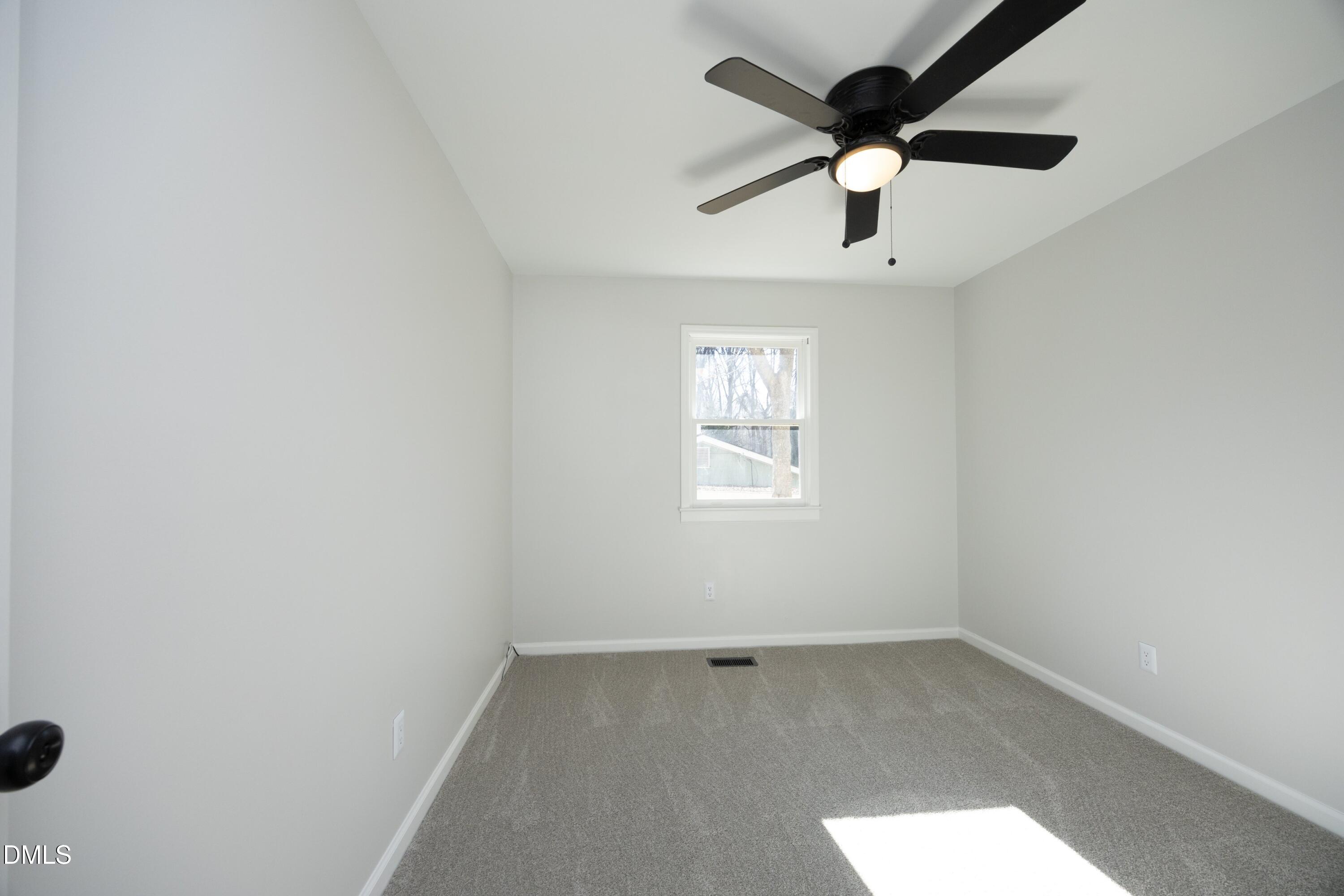 5108 Old Valley Street Raleigh, NC 27603 - Photo 23 of 37 an empty room with a window and a ceiling fan